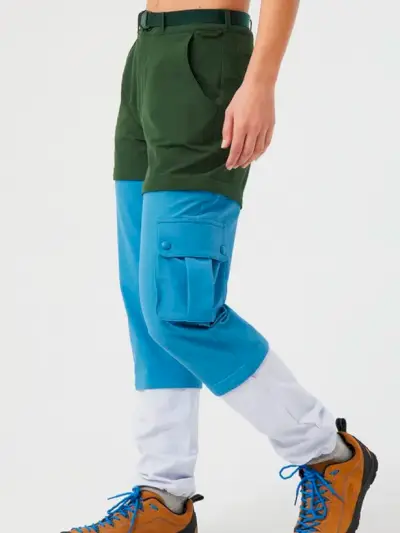 Model, ktorý má na sebe nohavice Outdoor Voices Rectrek Zip-Off vo farbách colorblock zelená, modrá, biela