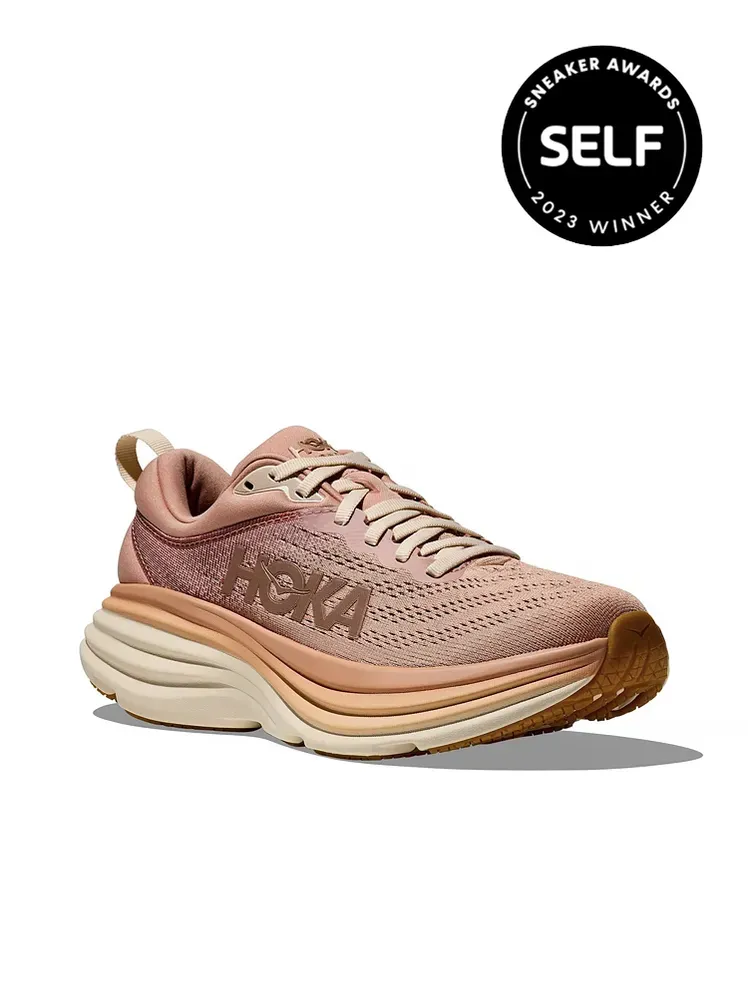 Sepatu kets Bondi 8 berwarna ungu muda dan tembaga dengan latar belakang putih