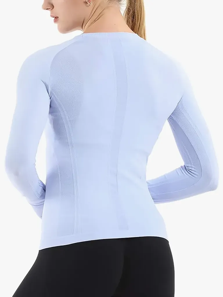 Sømløs treningsskjorte i myk blåfarge på modell på lys grå bakgrunn