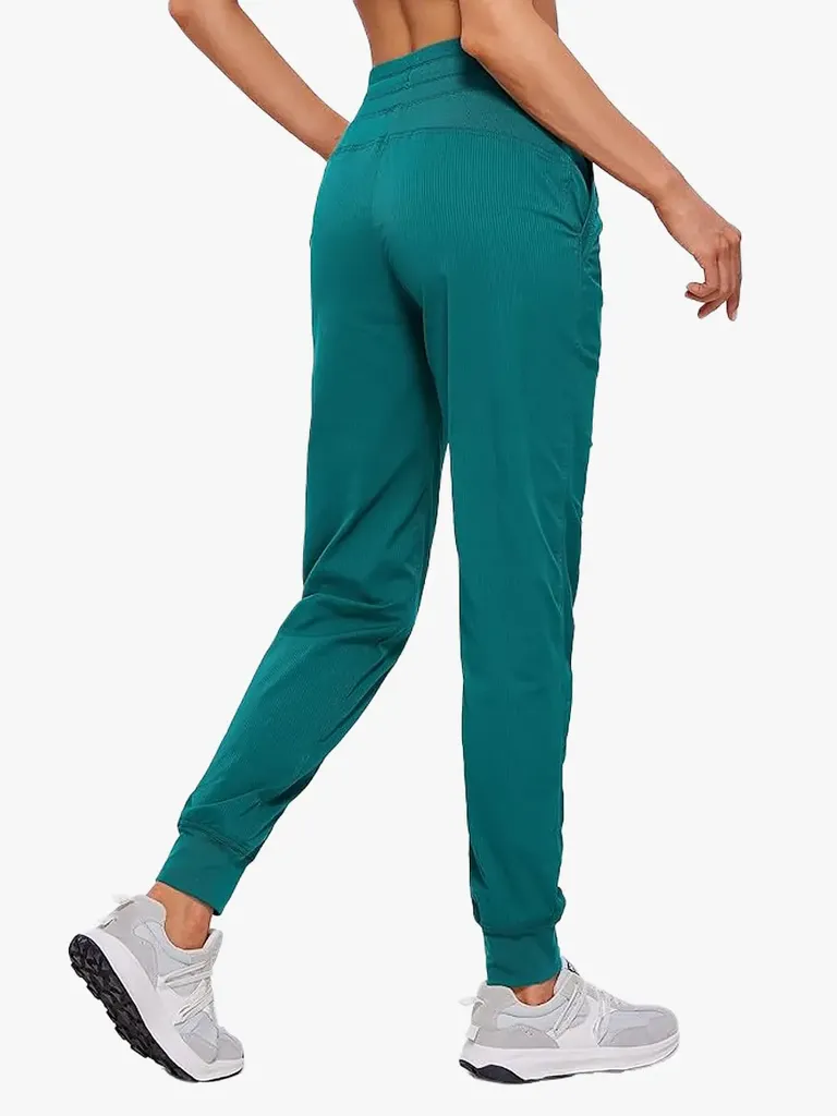 Lette treningsjoggere i fet grønn farge på modell på lys grå bakgrunn