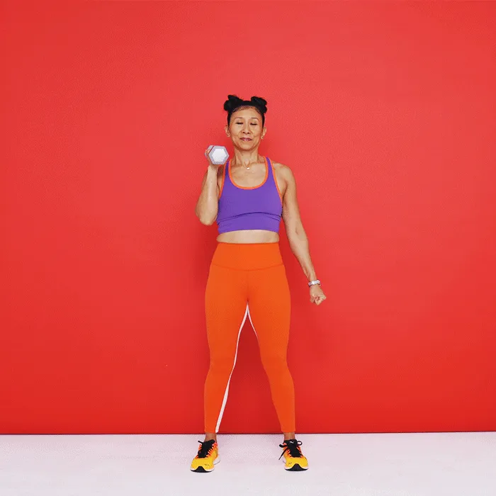 Tenez-vous debout, les pieds écartés à la largeur des hanches. Tenez un haltère dans votre main droite et posez-le à hauteur d