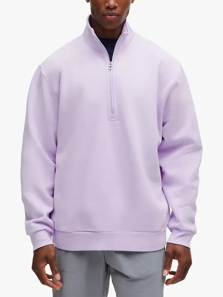 Lululemon Steady State Half Zip en composant griffé sur fond gris clair