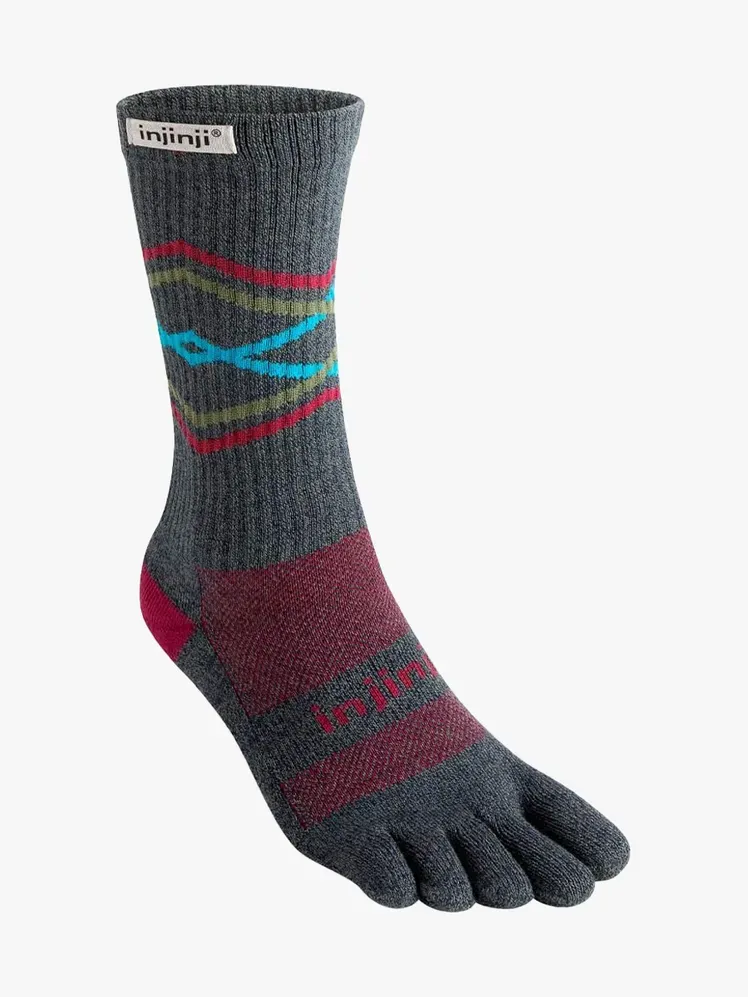 Calcetines Injinji Trail Midweight Crew con componente de la marca sobre fondo gris claro