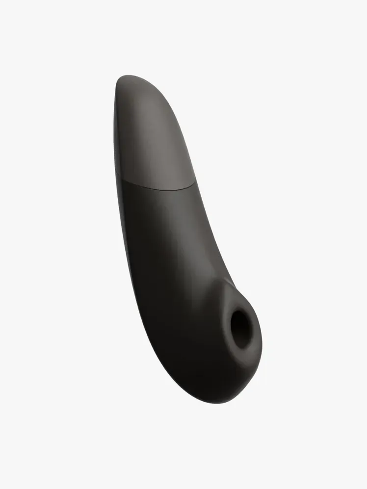 Womanizer Enhance в фірмовому компоненті на світло-сірому фоні