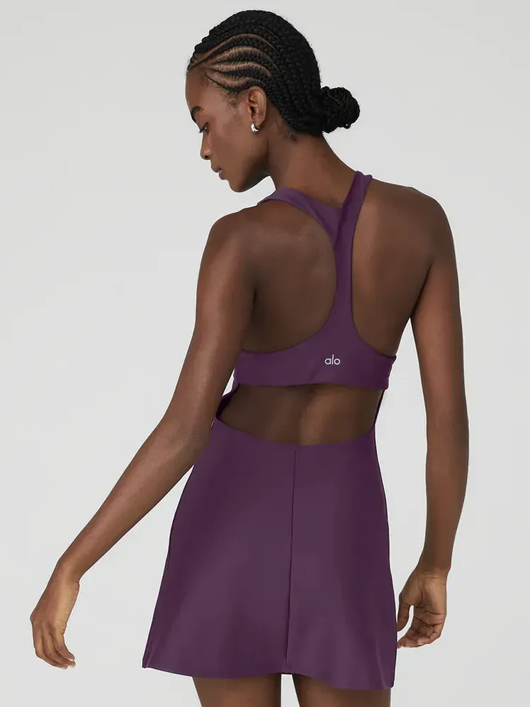 Airlift Fly Dress dengan warna ungu tebal pada model dengan latar belakang abu-abu