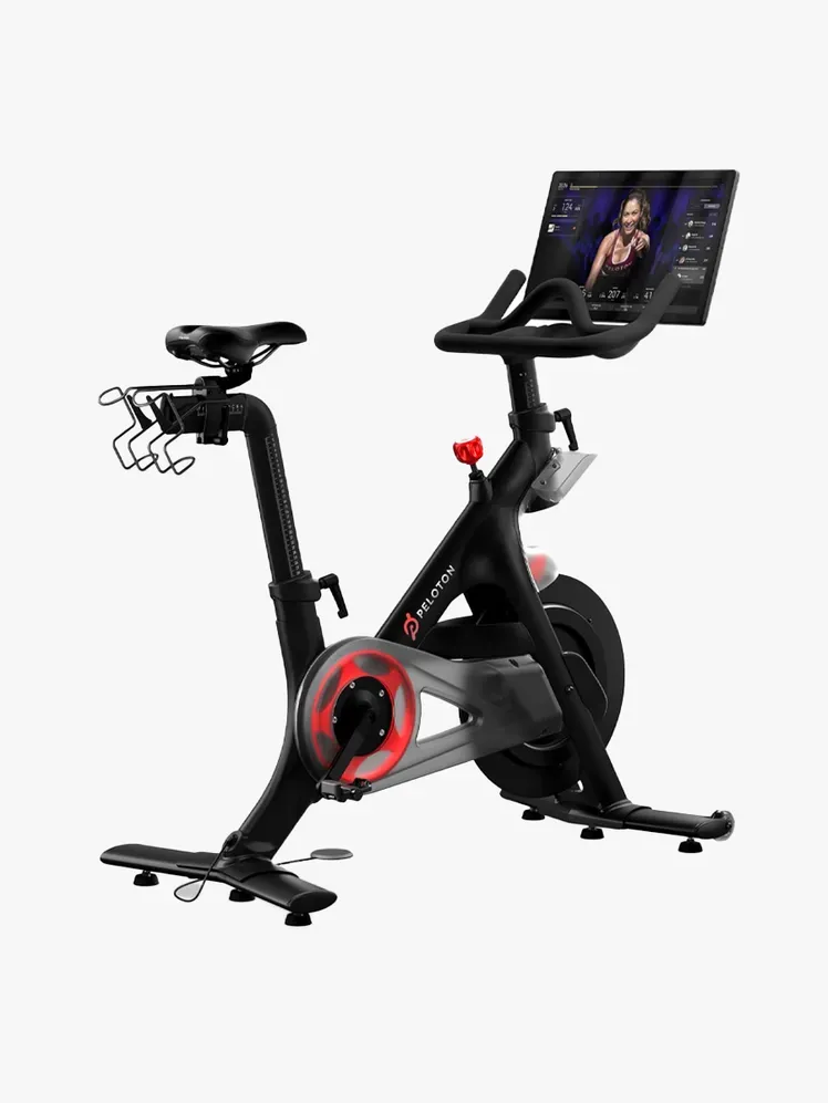 Peloton Original Bike ในส่วนประกอบของแบรนด์บนพื้นหลังสีเทาอ่อน