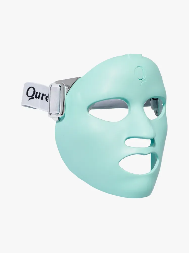 Qure Skincare Light Therapy Mask i merkekomponent på en lysegrå bakgrunn