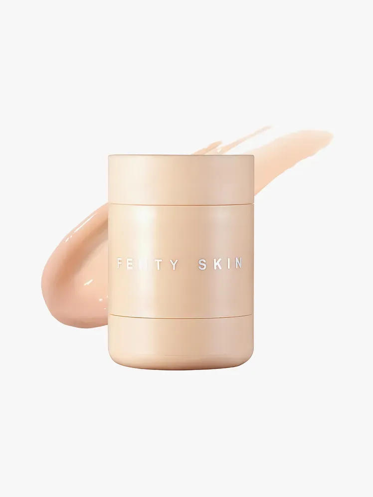 Màscara de llavis de recuperació intensiva de Puddin de peluix amb un component de préssec de marca a la part superior de la mostra sobre fons gris clar